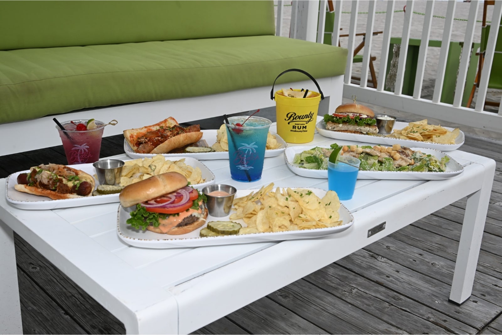a green couches and a table with umbrellas