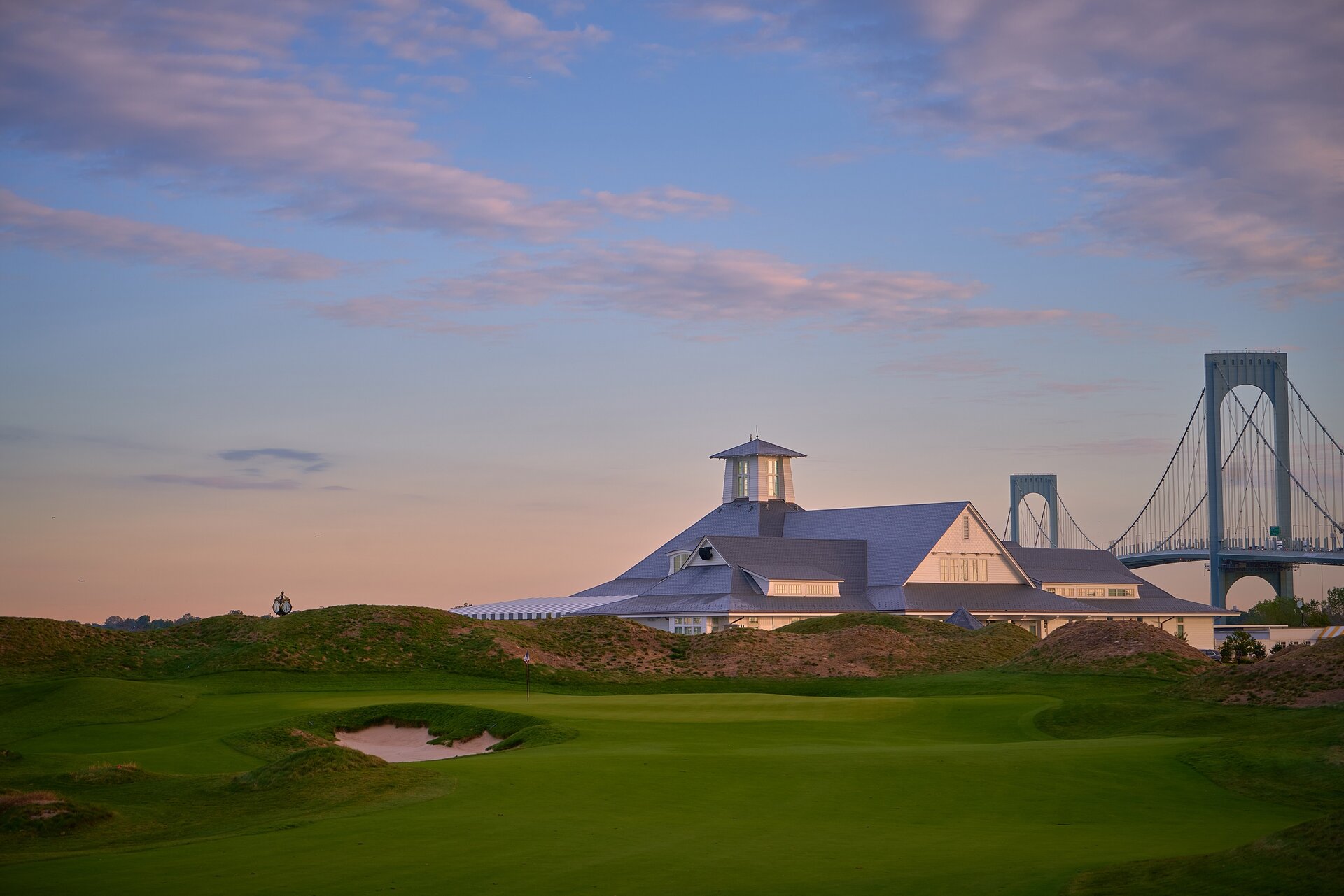 NYC Golf Course clubhouse with view of bridge at dusk