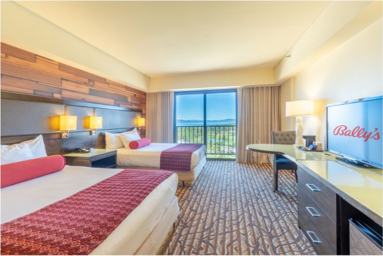 a room with two beds and a desk