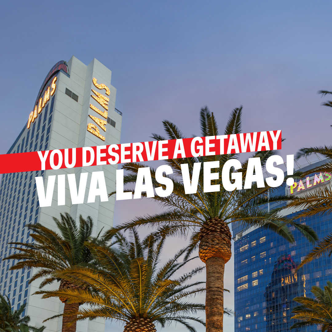 a group of palm trees in front of a building